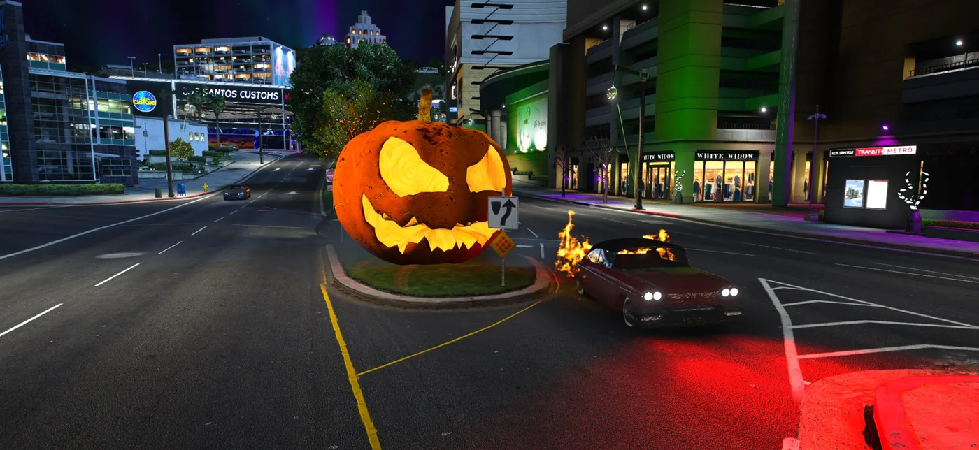 A dark classic car wreathed in flames racing past a giant jack-o'-lantern on a city street at night